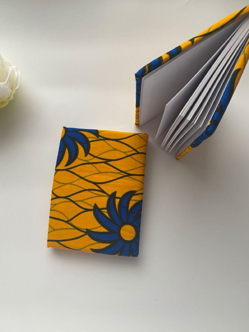 Handmade notebook covered in yellow and blue African print fabric